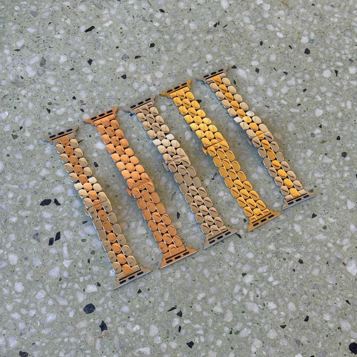 Set of five watch straps with a unique pattern on a textured surface