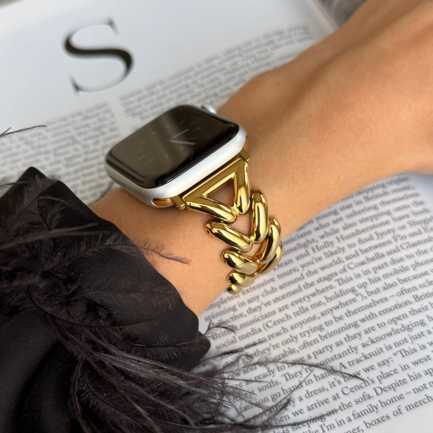 A close-up image of a person's wrist wearing a silver stainless steel Apple Watch band.
