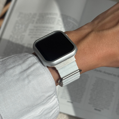Smartwatch on a wrist with a blurred book in the background with a Metal stainless steel apple watch case cover