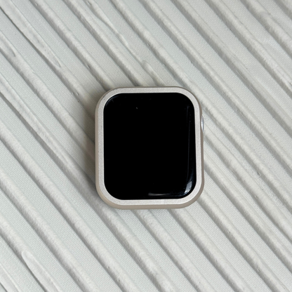 Smartwatch on a textured light gray surface with a Metal stainless steel apple watch case cover