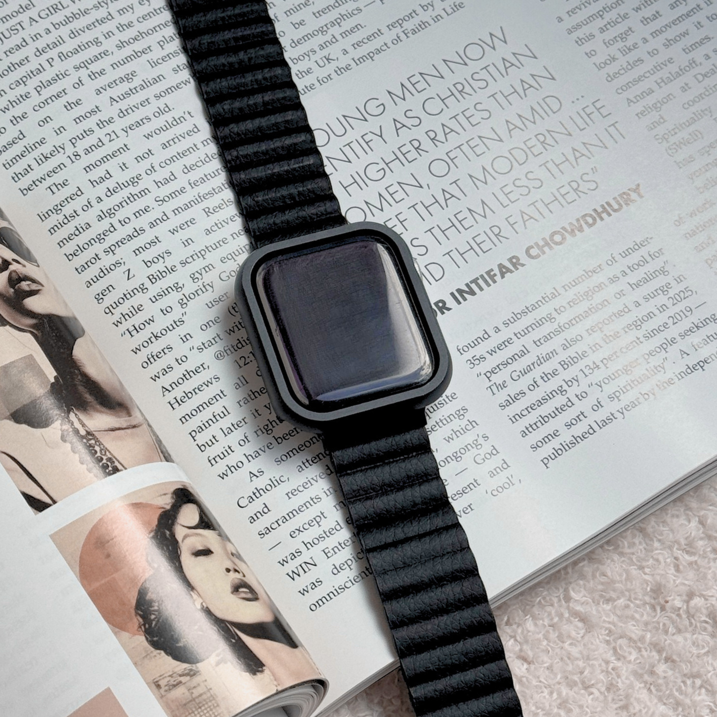 Smartwatch with a black band on an open magazine with a Metal stainless steel apple watch case cover