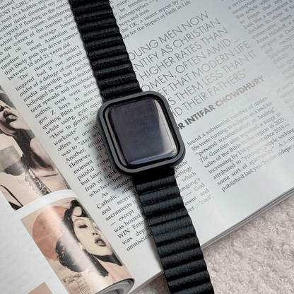 Smartwatch with a black band on an open magazine with a Metal stainless steel apple watch case cover