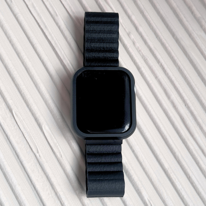 Black smartwatch with a matching band on a light gray background with a Metal stainless steel apple watch case cover