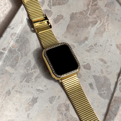 Gold apple watch with a black screen on a marble surface, Gold rhinestone apple watch case