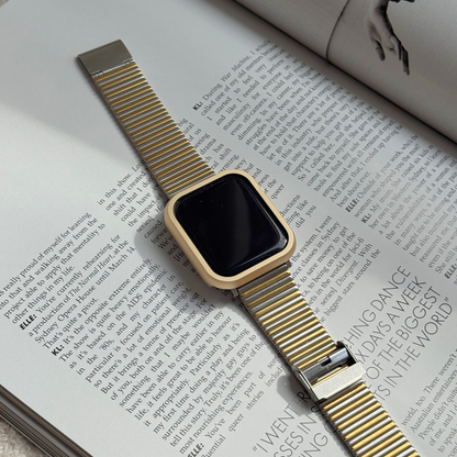 Gold smartwatch on an open magazine with a Metal stainless steel apple watch case cover on it