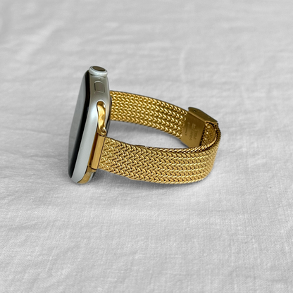 Gold woven mesh Apple Watch band photographed on white linen, stainless steel bracelet for Apple Watch 38mm to 49mm