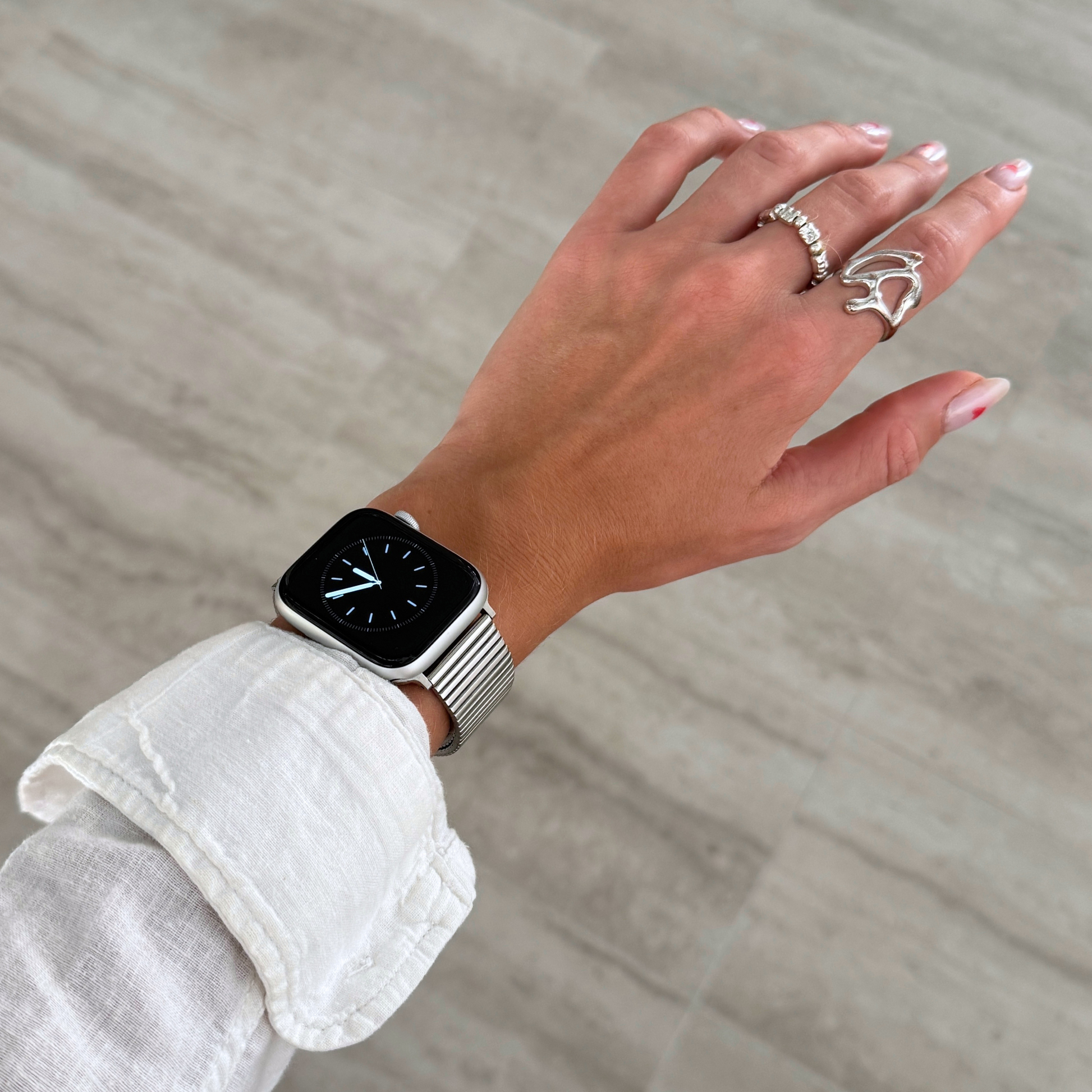 Stainless steel, waterproof Apple Watch band with a chic loop design. Features a multi-color finish and an easy-to-resize design for a perfect fit. Compatible with Apple Watch Series 1-10, SE, and Ultra.