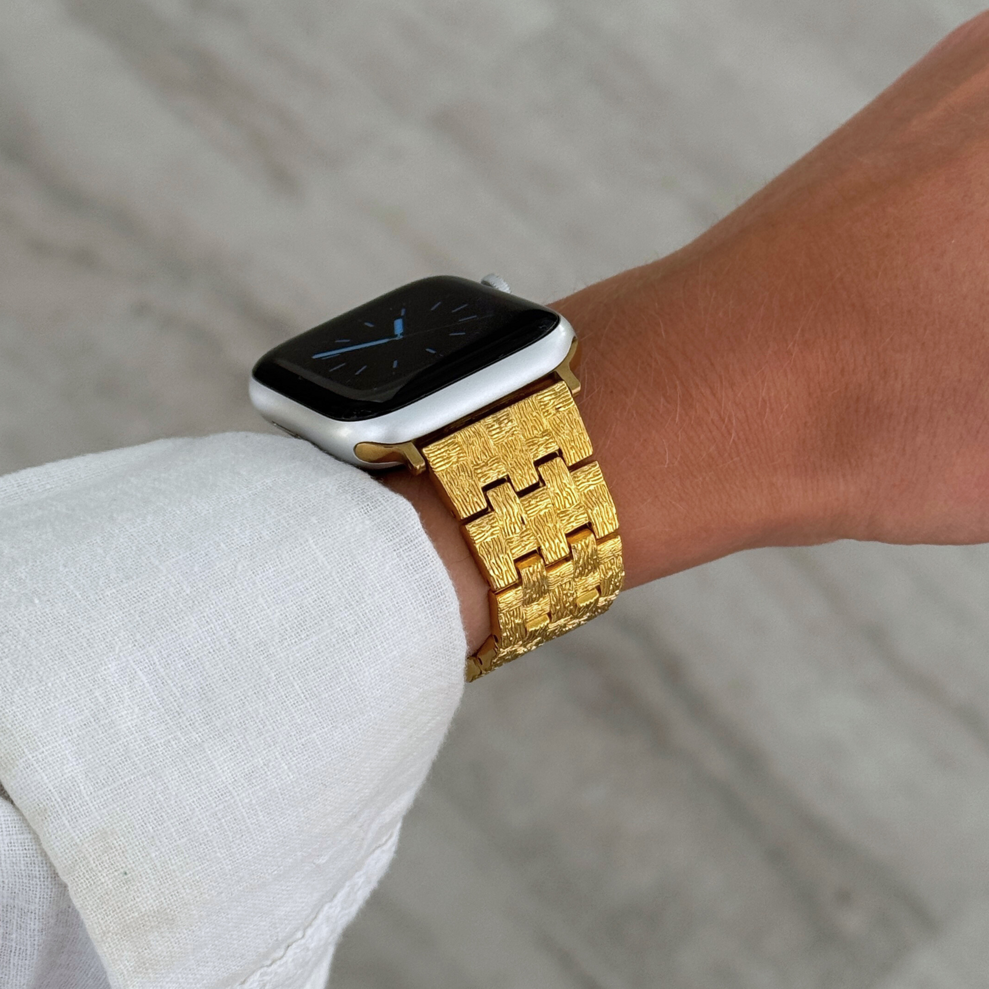 Vintage-inspired stainless steel Apple Watch band with an intricate baroque pattern. Features a mix of brushed matte and polished shine for a luxurious look. Compatible with Apple Watch Series 1-10, SE, and Ultra.
