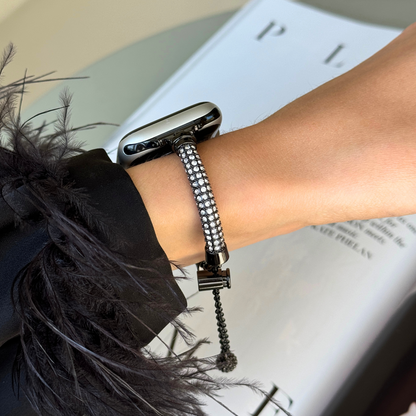 Black rhinestone Apple Watch band worn on a wrist with a feathered cuff, stainless metal for Apple Watch 38mm to 49mm