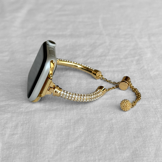 Gold rhinestone Apple Watch band lying on white linen, metal strap for Apple Watch 38mm, 40mm, 41mm, 42mm, 44mm, 45mm and 49mm