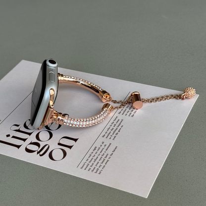 Rose gold rhinestone Apple Watch band propped upright on a white card, metal strap for Apple Watch 38mm to 49mm