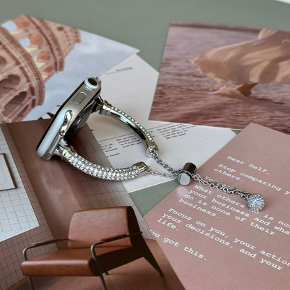 Silver rhinestone Apple Watch band lying flat on a printed note card, metal bracelet for Apple Watch 38mm to 49mm