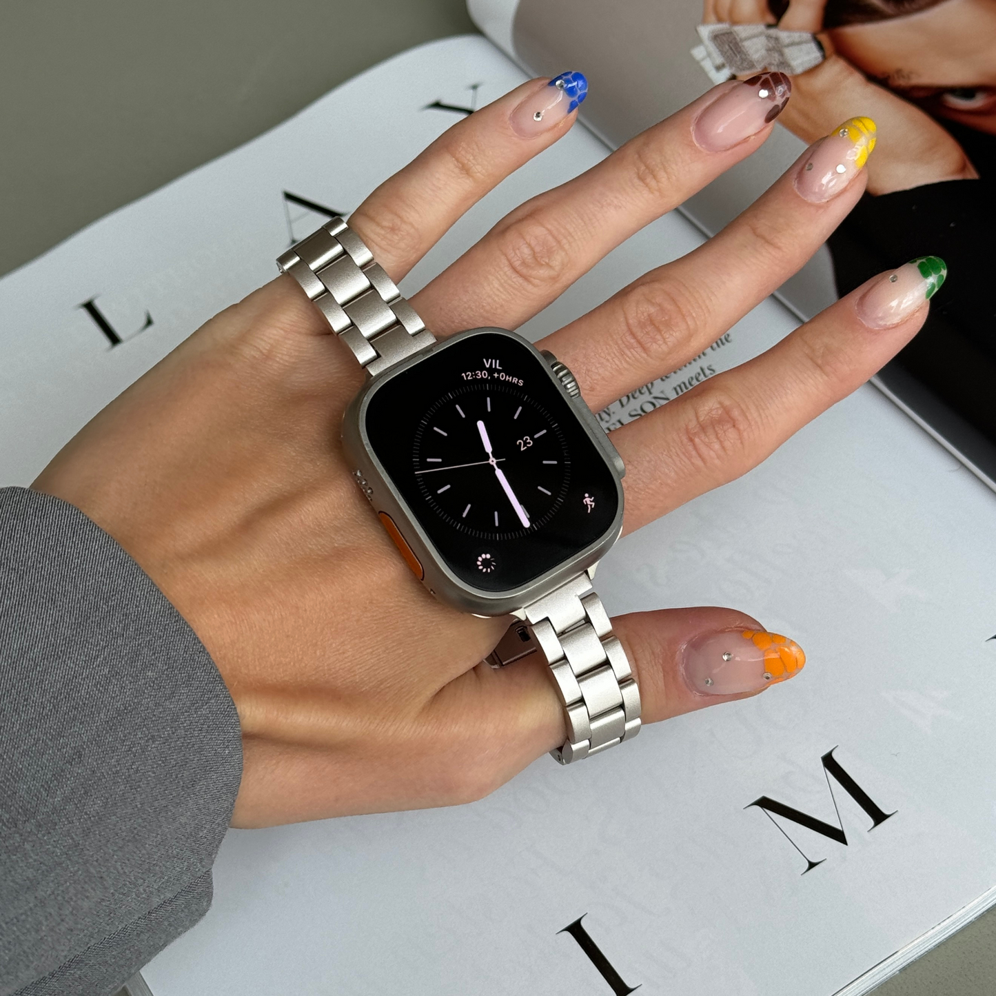 Starlight slim link Apple Watch band held in a hand with painted nails, stainless steel strap for Apple Watch 38mm, 40mm, 41mm, 42mm, 44mm, 45mm, 46mm and 49mm