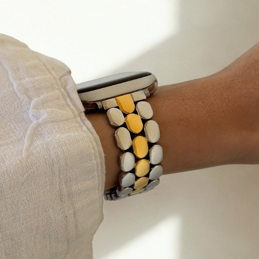 Wrist wearing a colorful bracelet with a neutral background