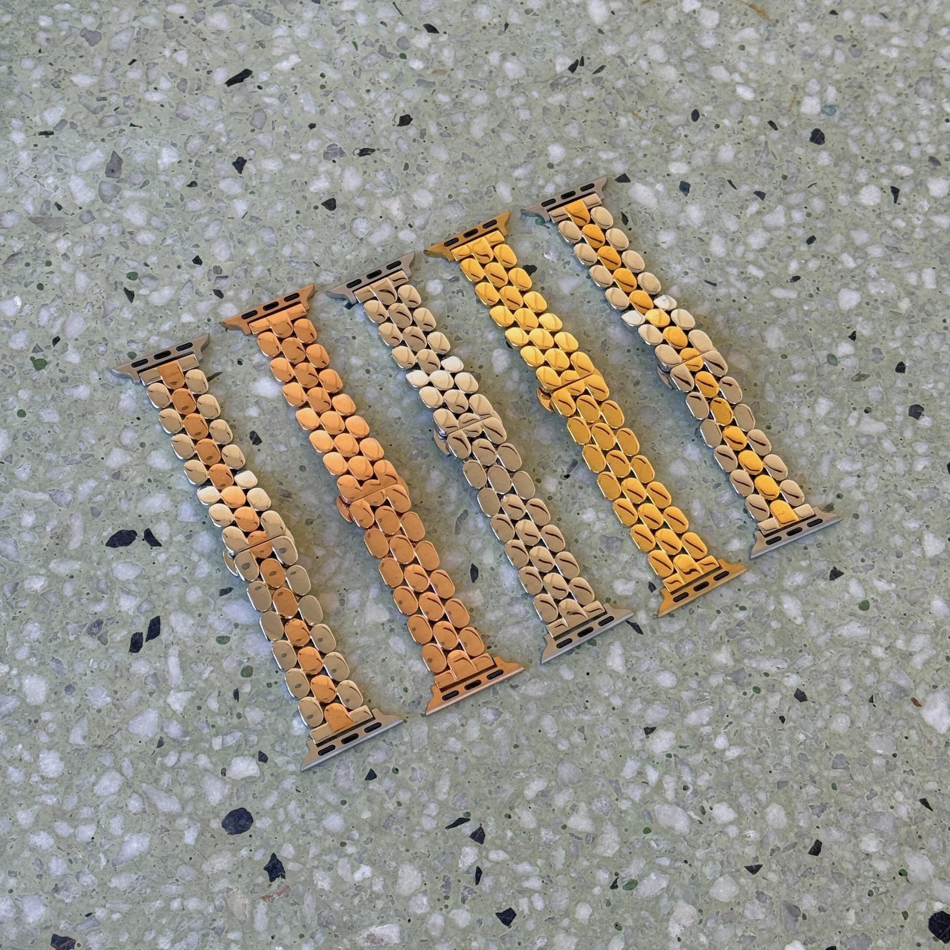 Set of five watch straps with a unique pattern on a textured surface