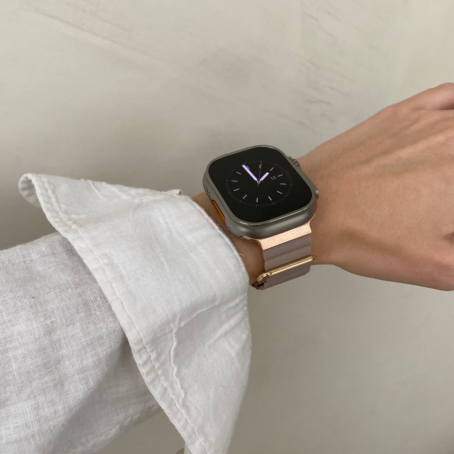 Smartwatch on a wrist with a neutral background