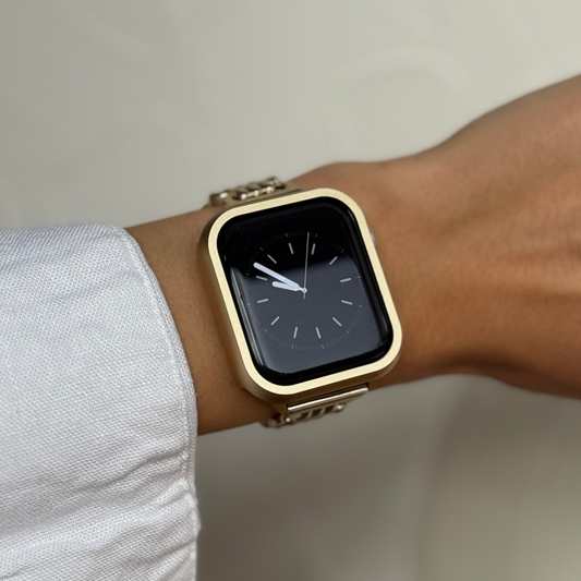 Gold smartwatch on a wrist with a neutral background